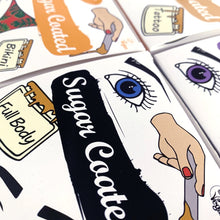 Load image into Gallery viewer, Top view of sugar coated boxes with view of logo and imagery